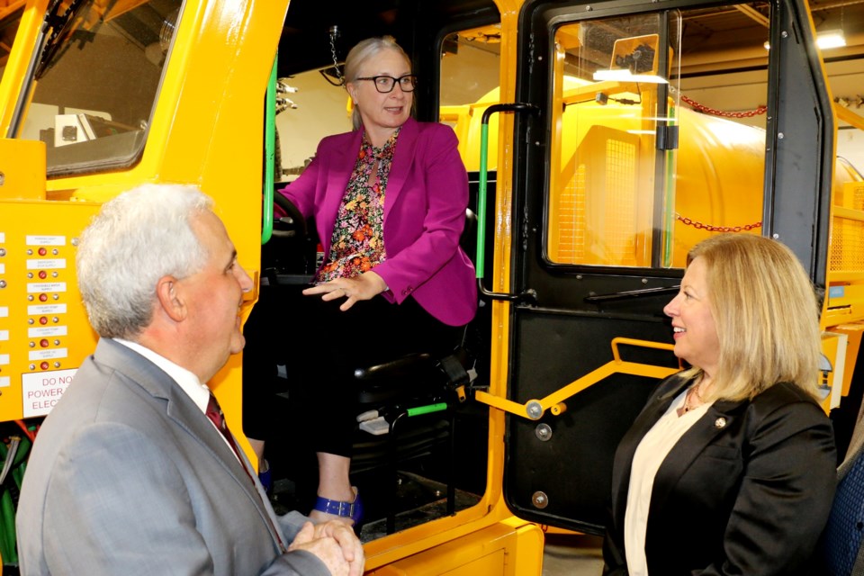 FedNor Minister Patty Hajdu, centre, sat at the controls of a MacLean Engineering BEV underground mining vehicle at Cambrian College Tuesday. She was joined by Nickel Belt MP Marc Serré, left, and Sudbury MP Viviane Lapointe, during a tour of the college's technology shops.