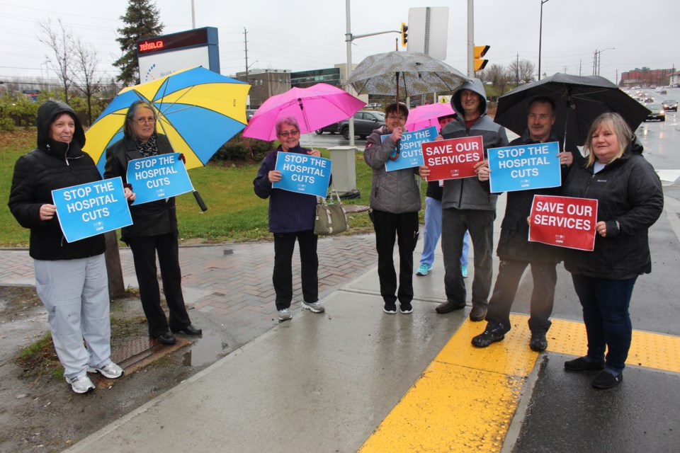 A handful of HSN employees braved some inclement weather on Tuesday as they rallied along Paris Street to send a message to Premier Doug Ford that Sudbury's hospital is not being properly funded. (Matt Durnan/Sudbury.com)