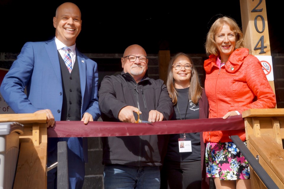 Participating in the ribbon-cutting at the reopening of the Elizabeth Fry Society of Northeastern Ontario on Oct. 7 is (from left) Sudbury MPP Jamie West, Mayor Brian Bigger, Cory Rosly of the Elizabeth Fry Society and Nickel Belt MPP France Gélinas.