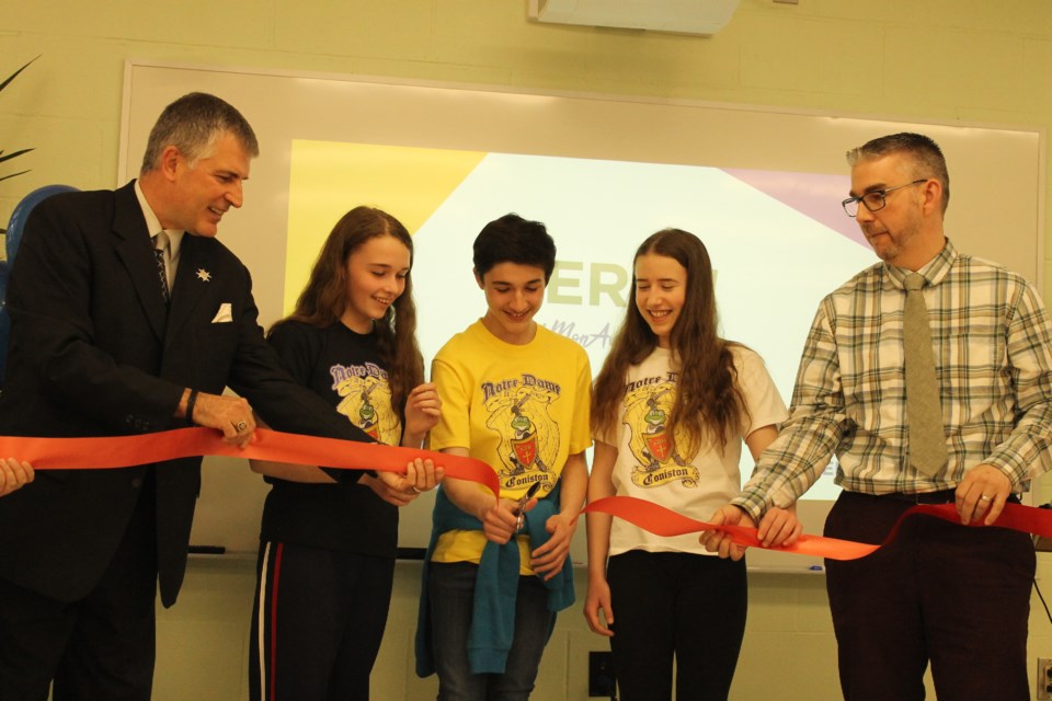 The ribbon was cut on École Notre-Dame de la Merci's revamped library May 6. From left are Paul Henry, superintendent with the CSCNO, students Zoe Booth, Kieon Audette and Vanessa Major, and École Notre-Dame de la Merci principal Yves Vaillancourt. (Annie Duncan/Sudbury.com)y