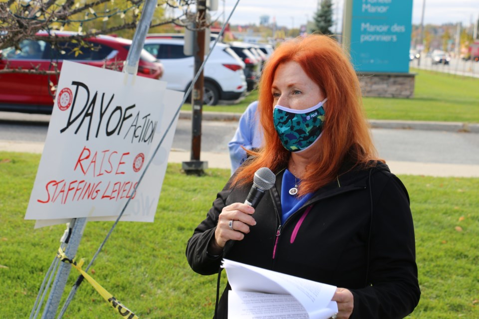 Lynn Logtenberg speaks of the struggles of helping to care for their father, a resident of a long-term care home during a protest event held in Sudbury Thursday. It was part of a province-wide day of action organized by the Ontario Health Coalition.  (Len Gillis / Sudbury.Com)