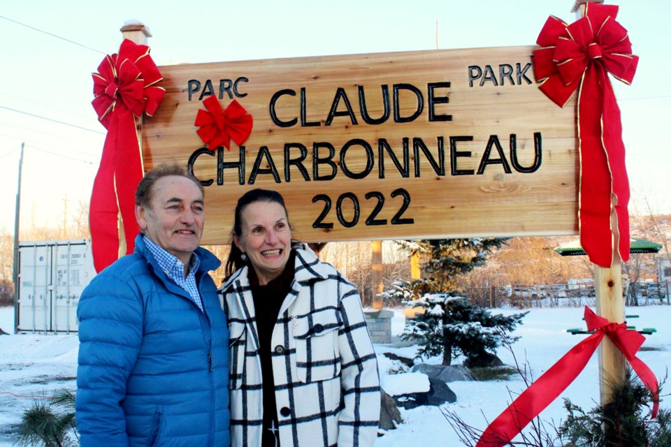Claude and Louise Charbonneau are seen next to a new sign renaming what was previously Percy Park in Claude’s honour, recognizing the more than 40,000 volunteer hours he has spent maintaining and improving the Flour Mill neighbourhood park. 