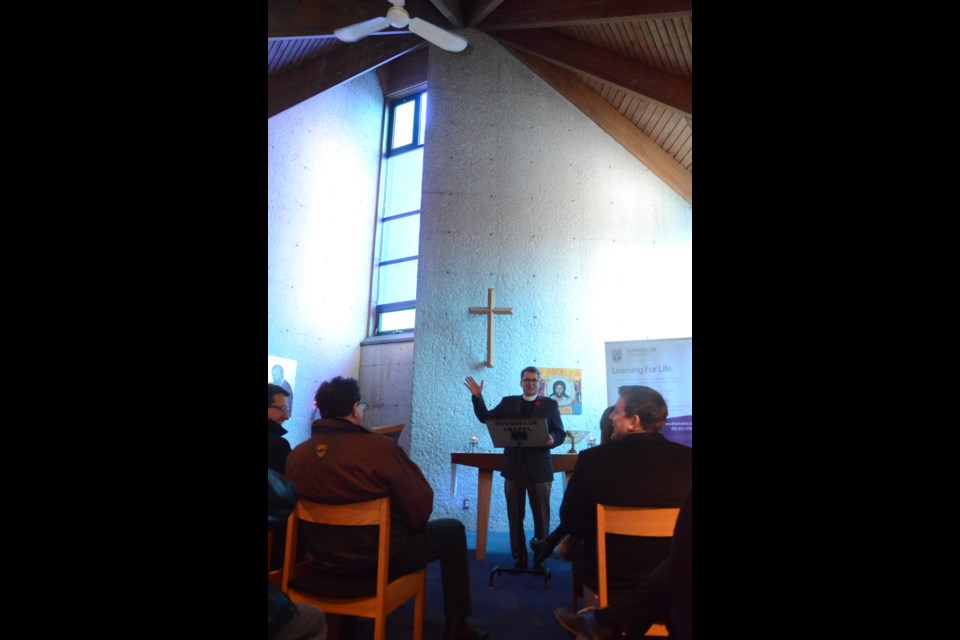 Rev. Robert Derrenbacker, president, provost and vice-chancellor of Thorneloe University, speaks to guests gathered at the Fielding Memorial Chapel of St. Mark to celebrate winning the Ontario Association of Architects Landmark Award and being listed in the City of Greater Sudbury's Heritage Registry. (Arron Pickard/Sudbury.com)