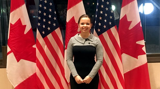 Frappier gets her photo taken in front of Canadian and U.S. flags in Ottawa at a special dinner in honour of Biden. Supplied