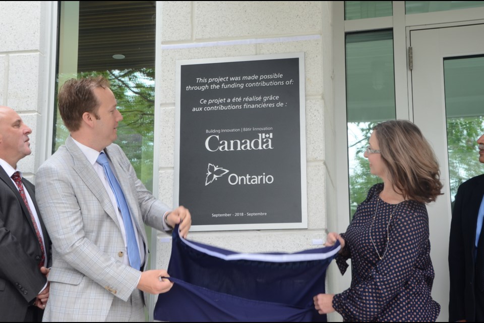 Sudbury MP Paul Lefebvre and Laurentian University board of governors chair Jennifer Witty unveil a plaque on the new Cliff Fielding Research, Innovation and Engineering Building during the grand opening ceremony on Monday. (Arron Pickard)