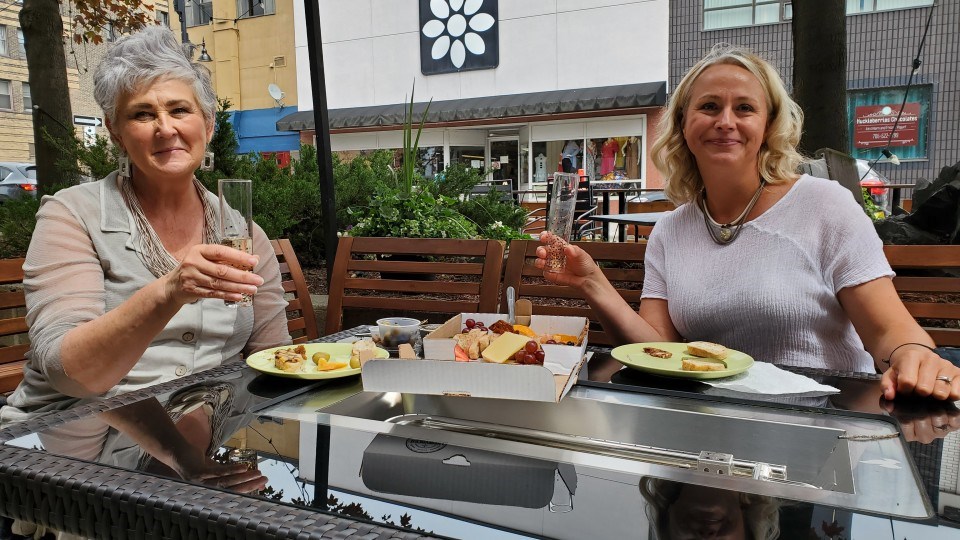 Ania Derecka, owner of Studio 35, was taking advantage of a break in the afternoon to enjoy some food and drink at the patio set up outside her Durham Street shop. She is joined by employee Linda Marsh.