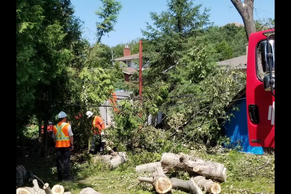 The work to restore power to hundreds of New Sudbury residents continues today, with about 300 customers still without electricity today after a powerful downburst Monday afternoon. (Supplied)