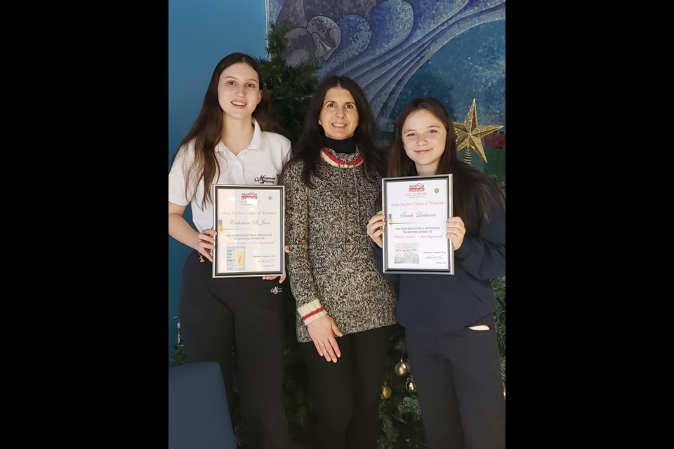 At left and right are Marymount Academy students Catherine St. Jean and Sarah Lachance, along with Action Sudbury member Tracey Adams. (Supplied)