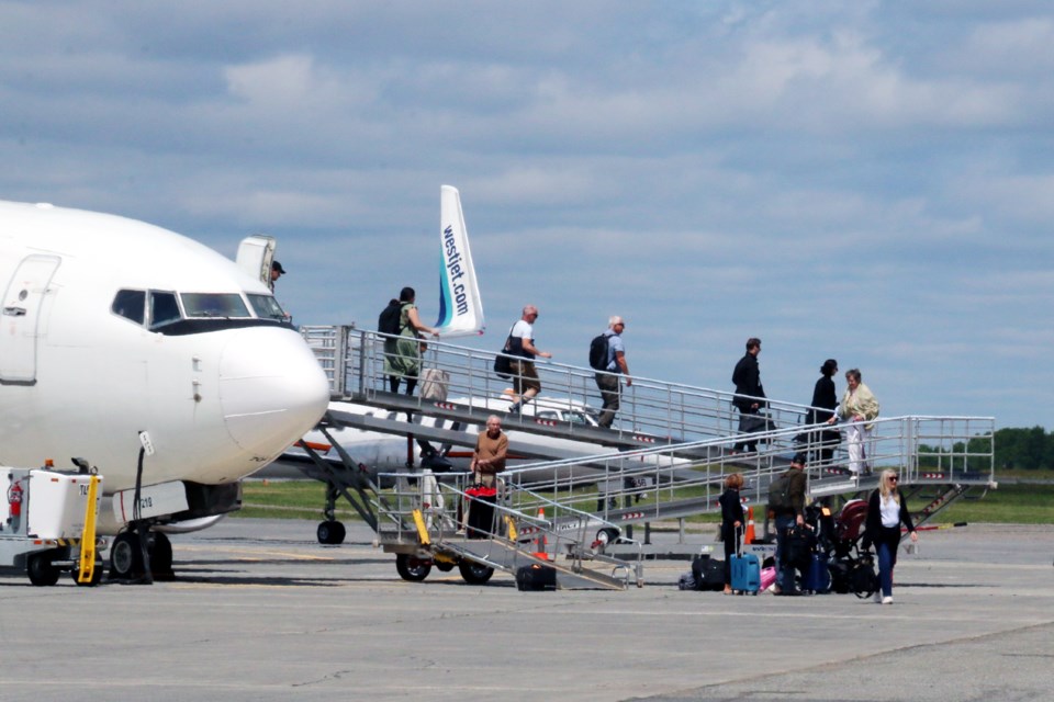The first passengers on WestJet’s new direct flight from Calgary to Sudbury deplane at the airport on June 12.
