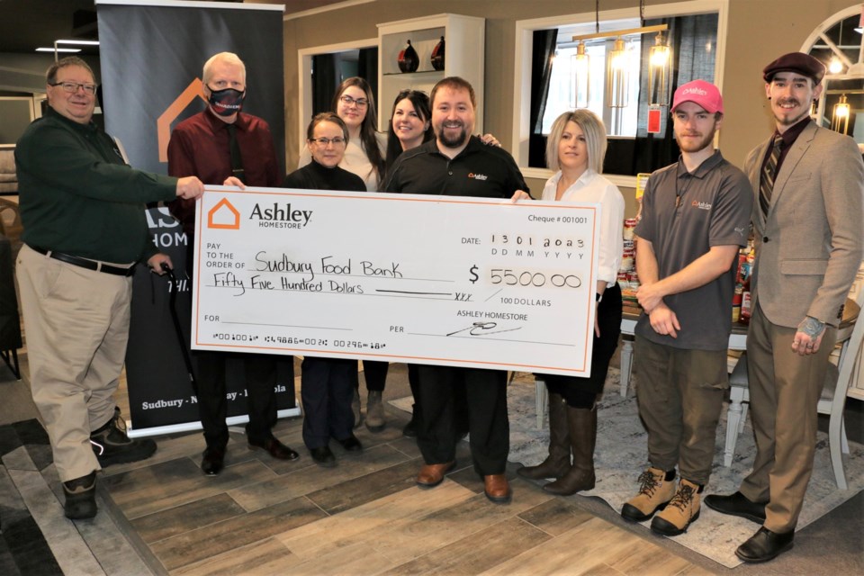 Daniel Xilon, left, the executive director of Banque d'aliments Sudbury Food Bank was pleased to accept a cheque from Ashley HomeStore on Friday for the December fundraising effort. Joining Xilon in the presentation were, left to right,  Shawn Ross, Rose Bilton, Emily Allard, Backy Carriere, Grant Carriere, Carolyn Allard, Dustin Durepos and Dustin Pretty.