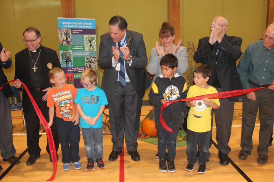 Officials and students cut the ribbon on the new St. David Catholic Elementary School Oct. 14. Photo by Heidi Ulrichsen.