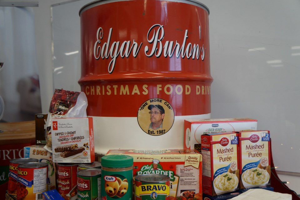 The official donation bin for the Edgar Burton Christmas Food Drive sits upon a small sleigh at the event.