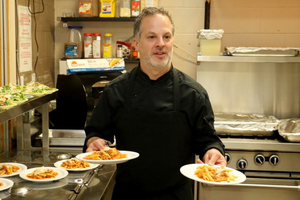 Mark Gregorini, owner of Verdicchio Ristorante, helped to cook and serve meals to the hungry during a special dinner held at the Elgin Street Mission.