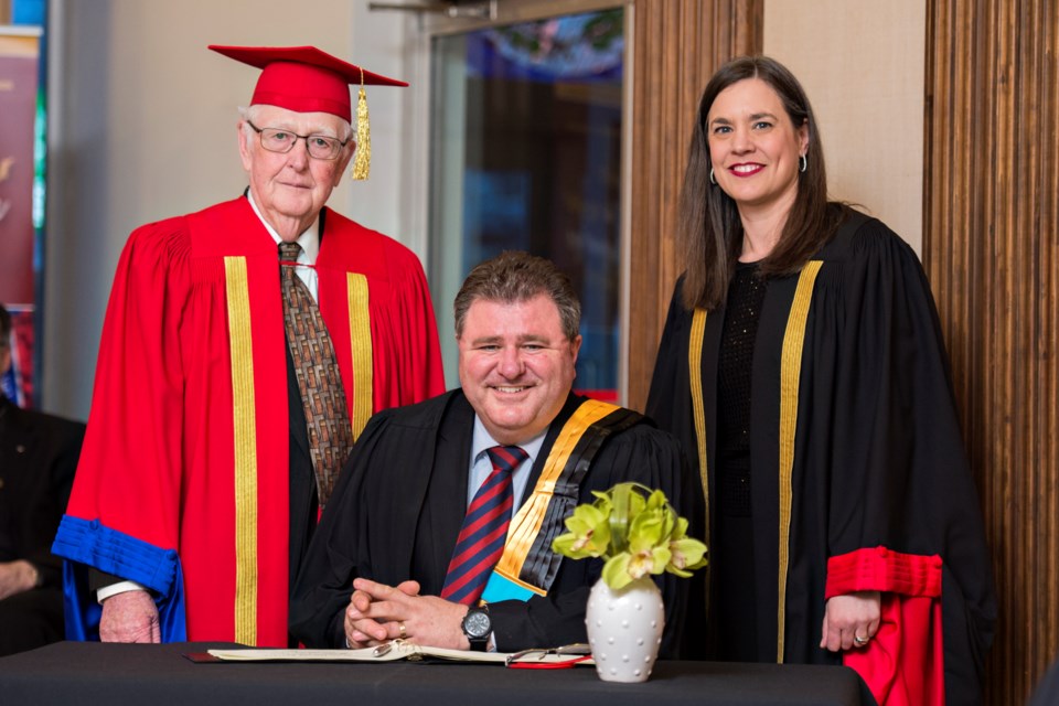 The University of Sudbury presented an honourary doctorate in sacred letters to Gilles LeVasseur (centre) during the federated university's annual awards ceremony late last month. He's seen here with chancellor Gérald Michel and president Sophie Bouffard. (Supplied) 