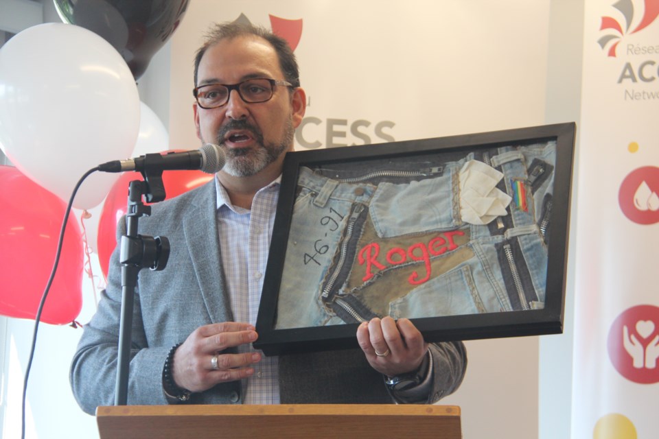 Sudbury MPP Glenn Thibeault shows off a quilt made from his late brother Roger's jeans that was presented to him three years ago by Réseau Access Network. He gave it back to the agency to hang at their new office in St. Andrew's Place. (Heidi Ulrichsen/Sudbury.com)