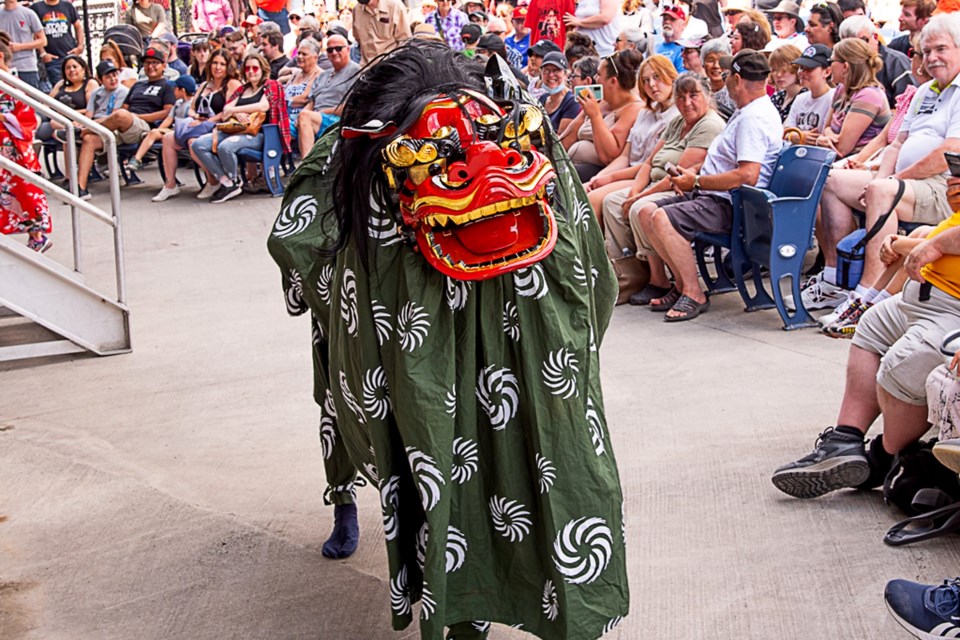 Hundreds of people watch as the Lion Dance wends its way through the crowd.
