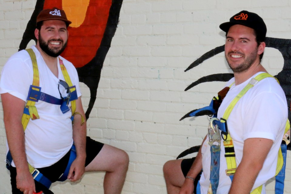 Chris Mitchell, left, and his twin brother Greg Mitchell were part of the Up Here festival in Sudbury this past week. The brothers from Halifax are mural painters who created a new downtown mural on a building on Durham Street.