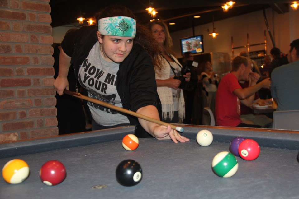 Second-year technical support and stage management student Jay Gamache-Howard shoots some pool at Collège Boréal's newly-revamped pub Sept. 19. Photo by Heidi Ulrichsen.