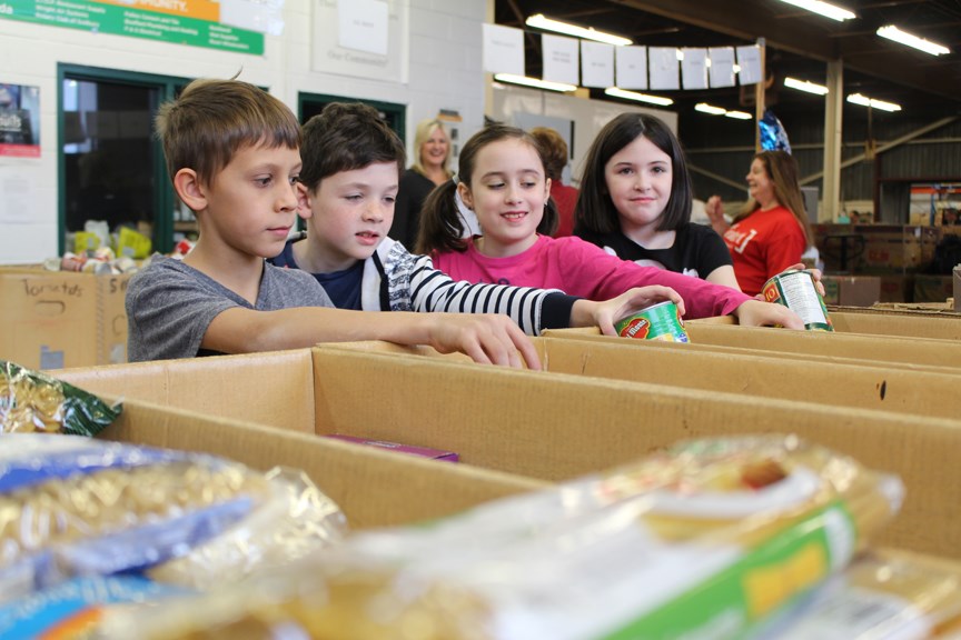 Grade 4 Princess Anne students (l-r) Aundiey Debossige, Griffen Bauer, Zahra Covell, Charlotte Goodwin helped sort food items during the Edgar Burton Christmas Food Drive & Kids Helping Kids Campaign wrap-up Dec. 19. (Heather Green-Oliver/Sudbury.com)