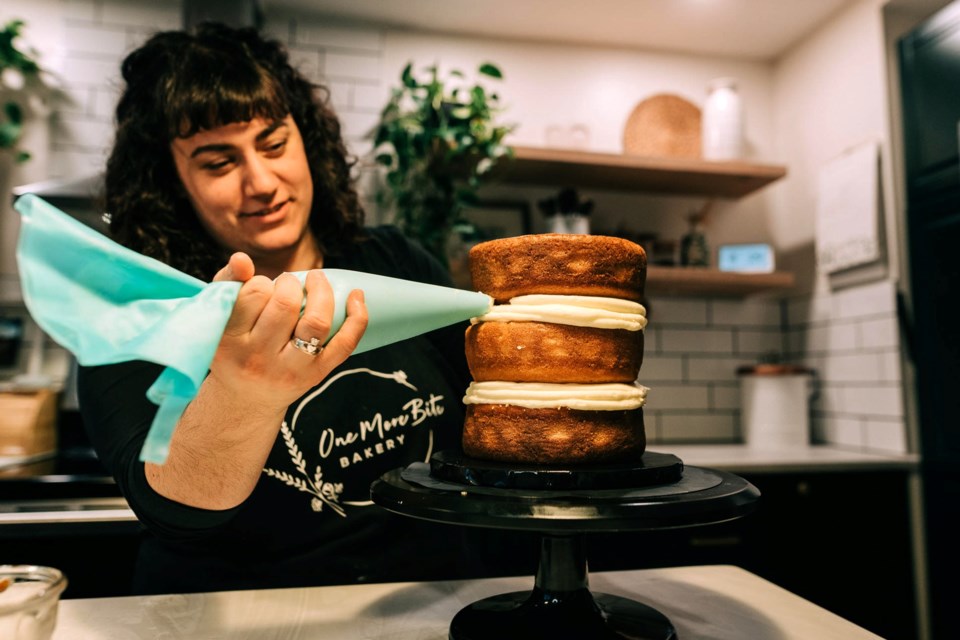 Courtney Audette begins to ice a delicious peach-infused cake at her home which is the business headquarters for One Bite Bakery.