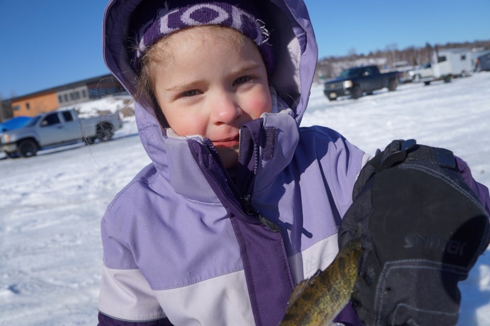 Valya Lafond shows off the very first fish she’s ever caught at the Fishing for a Cure event in Ramsey Lake on Feb. 20. Valya was fishing with her parents, Erin Lafond and Rick Blais.