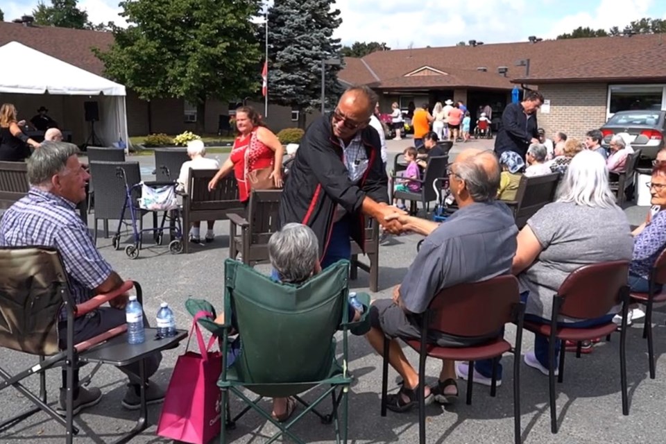 Ward 11 Coun. Bill Leduc, who is seeking re-election, is seen shaking hands with seniors during Grandparents’ Day at Chartwell Westmount on William Retirement Residence on Sept. 11. This image is a screenshot from a campaign video. 