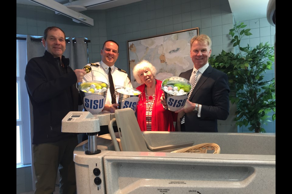 The second annual SISU Ball Drop Lottery kicked off this morning at Finlandia Village with a ceremonial ball drop. L-R: Brian Ramakko from Ramakko's Source for Adventure, Greater Sudbury Fire Services assistant deputy fire chief Jesse O'Shell, Finlandia resident Louise Mokohonuk, Ed Reilly of Freelandt Caldwell Reilly. (Heather Green-Oliver/Sudbury.com)
