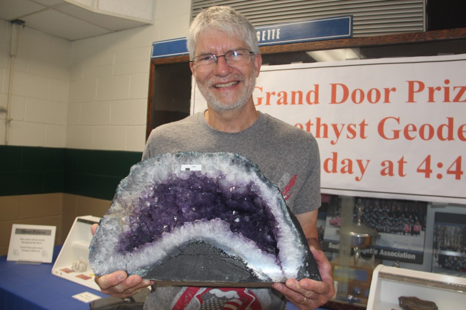 Sudbury Rock and Lapidary Society member Brian O'Hearn shows off the door prize at the Sudbury Gem and Mineral Show — a large, Brazilian amethyst geode valued at $750. (Heidi Ulrichsen/Sudbury.com)

