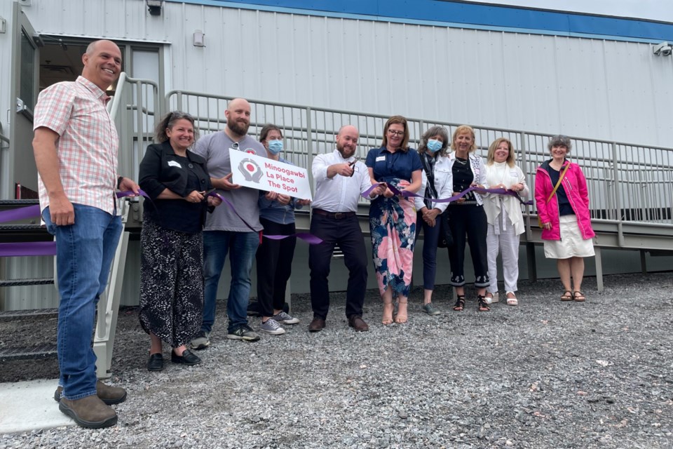 Ward 4 Coun. Geoff McCausland cuts the ribbon to open the city's supervised consumption site at 24 Energy Court on July 21.