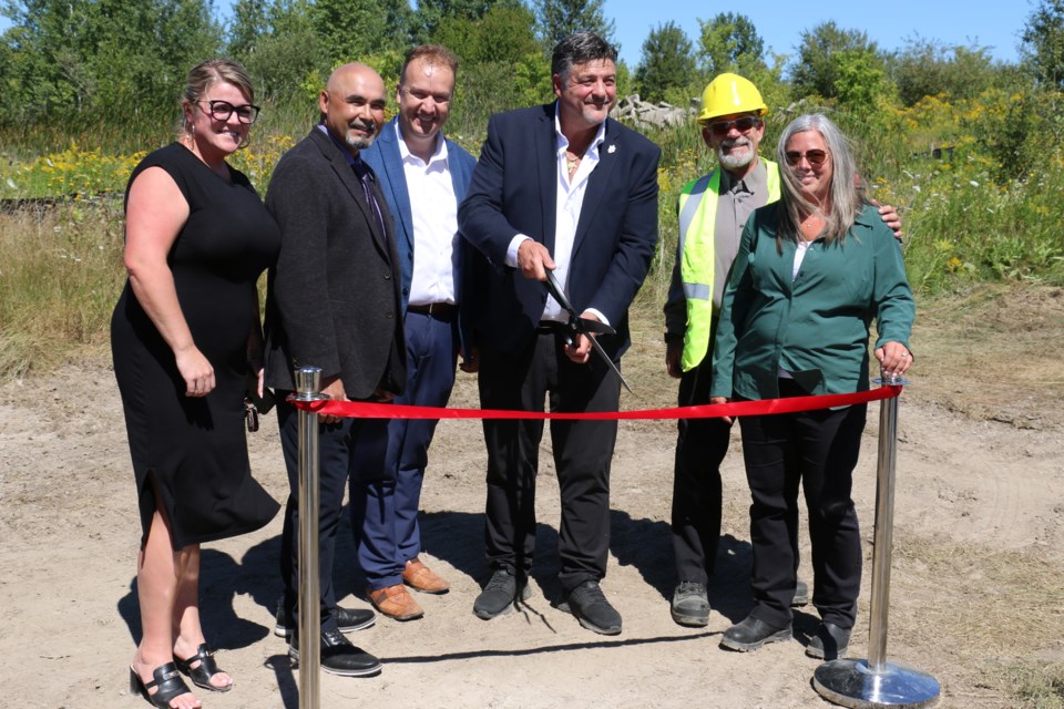 Sudbury Mayor Paul Lefebvre joins developer Dario Zulich (centre) to ‘cut the red tape’ for the official opening of a new industrial/business park at the site of the Kingsway Employment District on Aug. 20
