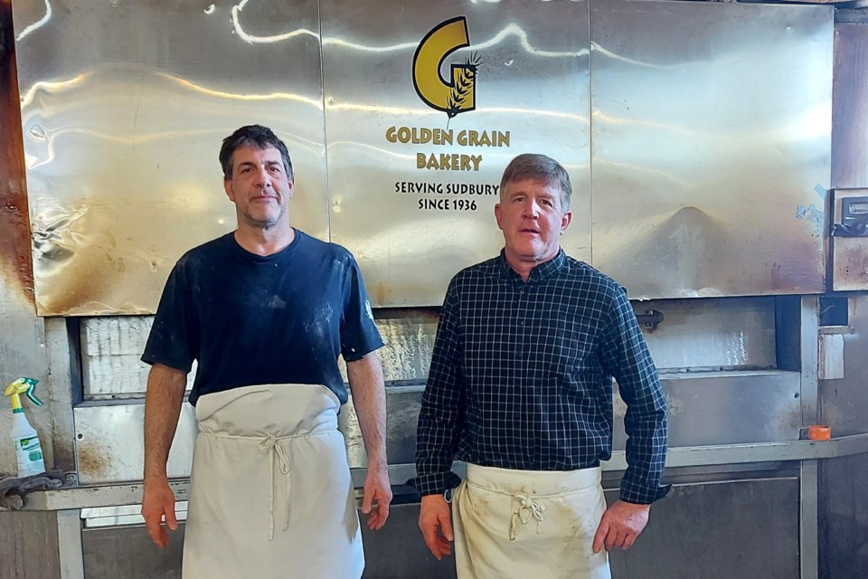 From left to right, brothers Dave and John Andlar stand near an oven inside Golden Grain Bakery in downtown Sudbury. The brothers have been working at the bakery since they became teenagers. They are now co-owners, following in their father and grandfather’s footsteps.