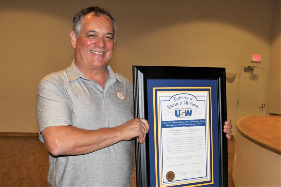 Local 6500 president Nick Larochelle was pleased to receive the new United Steelworkers charter. The original charter was destroyed by fire in 2008.