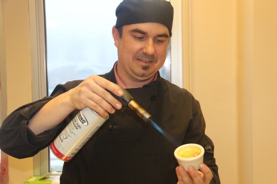 Nick Demetroff, kitchen operations manager with The Keg Steakhouse and Bar in Sudbury, prepares some crème brulee at a Wednesday press conference launching the March 31 Taste Street fundraiser for the Health Sciences North Foundation. Photo by Heidi Ulrichsen.
