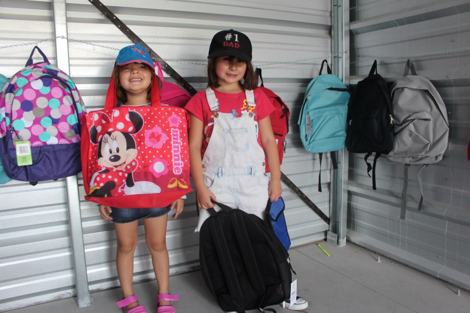 Sisters Alyssa, 6, and Alexandria, 7, show off their new school supplies at Backpack Buddies. (Matt Durnan/Sudbury.com)