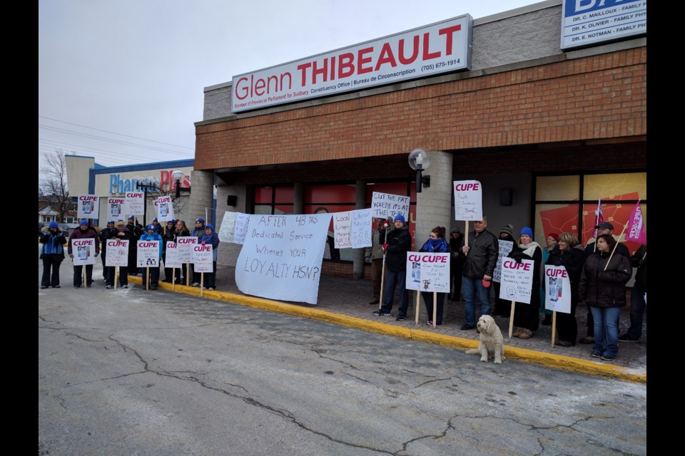  Workers with Sudbury Hospital Services, which cleans linens and laundry for Health Sciences North, were outside Sudbury MPP Glenn Thibeault's office Wednesday afternoon to fight for their jobs following the announcement in the hospital plans to change providers. Photo by Jonathan Migneault.