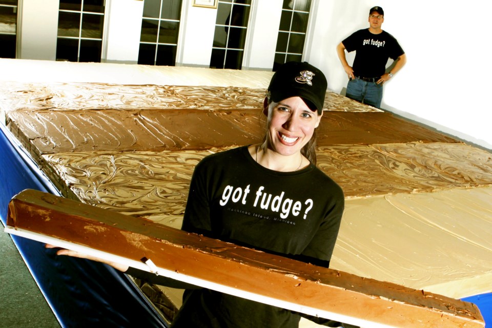 In a 2010 photo, Chantelle Gorham and her husband, David Kurtis, showcase their Guinness World Record-holding slab of fudge at their factory in Levack. The couple started making fudge commercially 22 years ago and now service customers all over North America. 