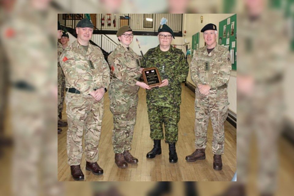 On March 8, Huntington University president and vice-chancellor and Irish Regiment honourary colonel Kevin McCormick, in green, awards a plaque to 1st Northern Ireland Battalion ACF Probationary Instructor Ellie May Wilson (centre left), flanked by Captain Gary Miniss (left) and Colonel Adrian Donaldson, MBE, Commandant (right). 