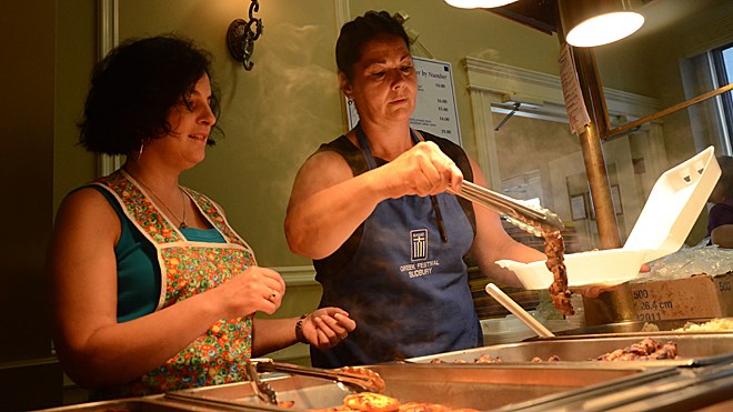Anna Tyrkos, right, and Olympia Mitsopoulos serve up some Greek fare at the annual Greek Festival on Sunday. Photo by Arron Pickard.