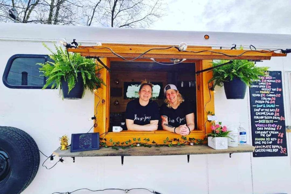 Meet Christina and Rachel, the faces at the wooden-framed window of Kina’s Unbridled Graze stationed in Azilda. This gourmet food truck offers customers healthier food-to-go options. Rachel often prepares salads, paninis and everything on the fridge side while Melissa enjoys customer service, flavour shot drinks and taking payments. Both have been in the food business for years.