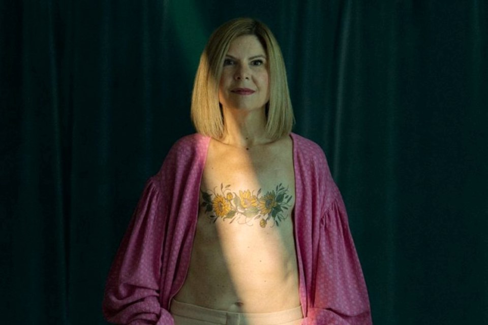 Weather Network broadcaster Kim MacDonald shows her mastectomy tattoo. 