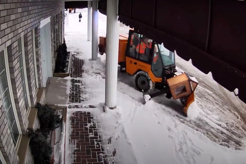 A screenshot from a video Levack resident Chantelle Gorham posted to social media in which a sidewalk plow is seen knocking over a free little library and damaging two pillars. 