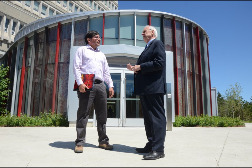 Charles Hopkins, UNESCO chair at York University in Toronto, speaks with Darrel Manitowabi, associate professor, School of Northern and Community Studies at Laurentian University following a press conference to announce a federal government grant of $250,000 to Laurentian University to conduct a research project into Indigenous education. (Arron Pickard/Sudbury.com)
