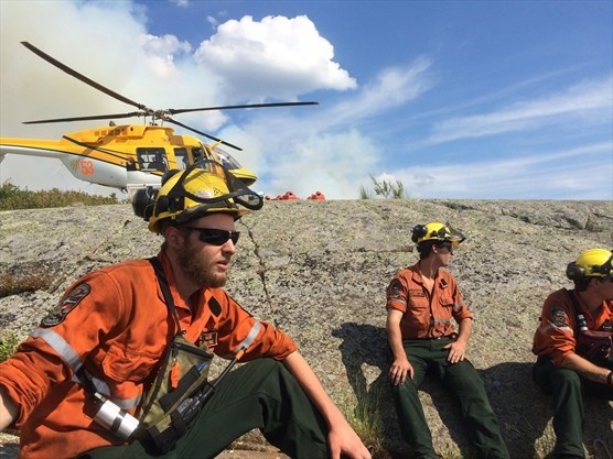 Ministry of Natural Resources and Forestry Fire Rangers take a breather during fire suppression in the French River area. (Shawn Rae photo)
