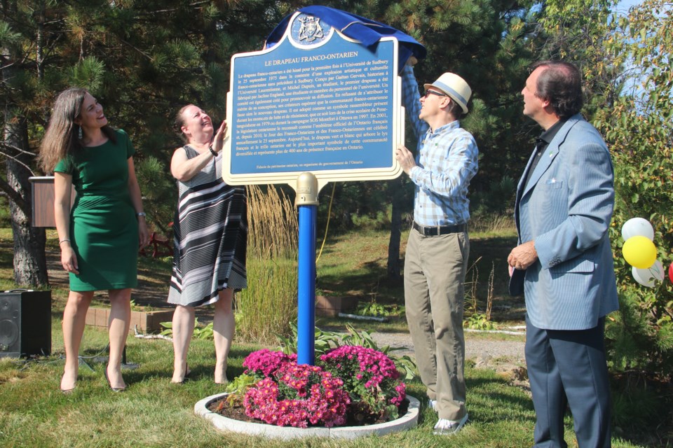 (From left) Sophie Bouffard, Joanne Gervais, Jean-Yves Peltier and Donald Obonsawin unveiled the Ontario Heritage Trust about the history of the Franco-Ontarian flag on the University of Sudbury's campus Sept. 25. (Heidi Ulrichsen/Sudbury.com)
