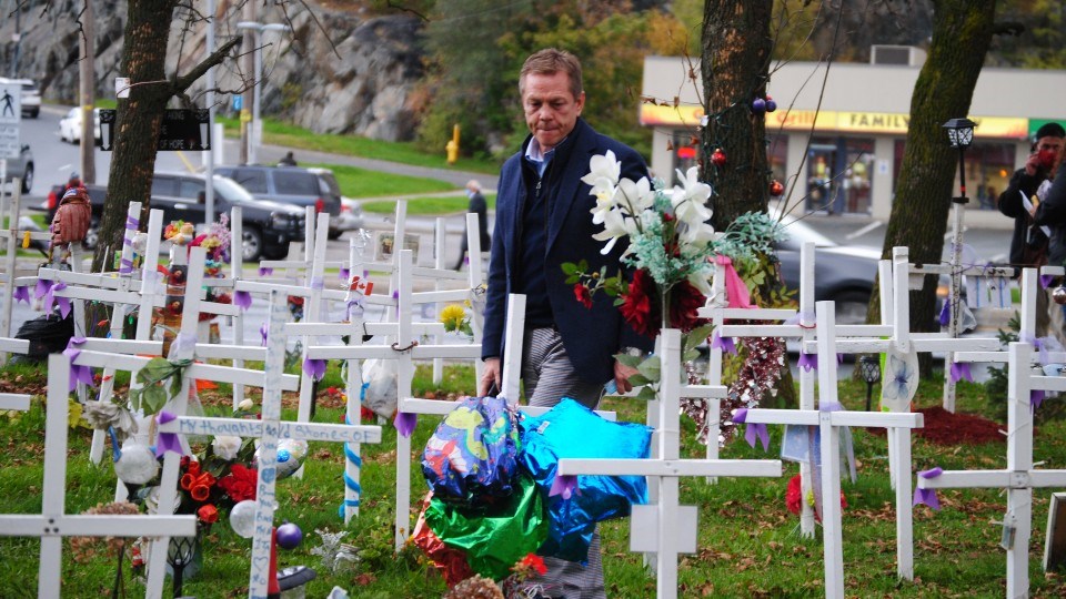 Ontario Medical Association CEO Allan O'Dette visits the Crosses for Change opioid memorial during a stop in Sudbury on Oct. 24.