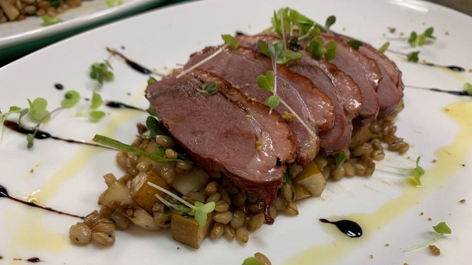 Anitra affumicata includes cast-iron smoked King Cole duck breast, roasted beets, bosc pears,arugula and local barley berry salad, served with a balsamic reduction and pistachio dust.