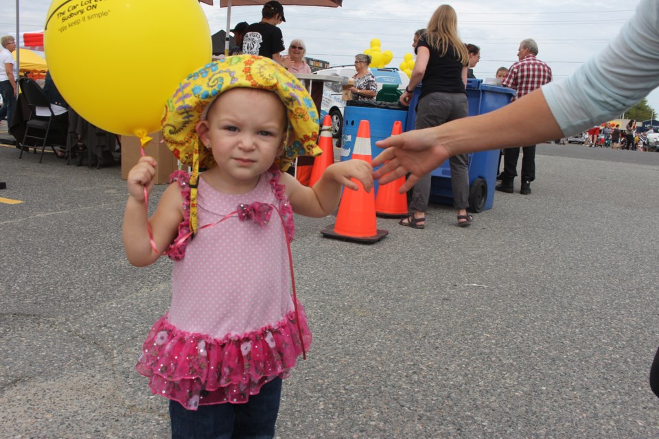 18-month-old Ellora Rice was at the New Sudbury Centre parking lot Saturday afternoon with her mom to take in the family-friendly activities for New Sudbury Days. Photo by Jonathan Migneault.