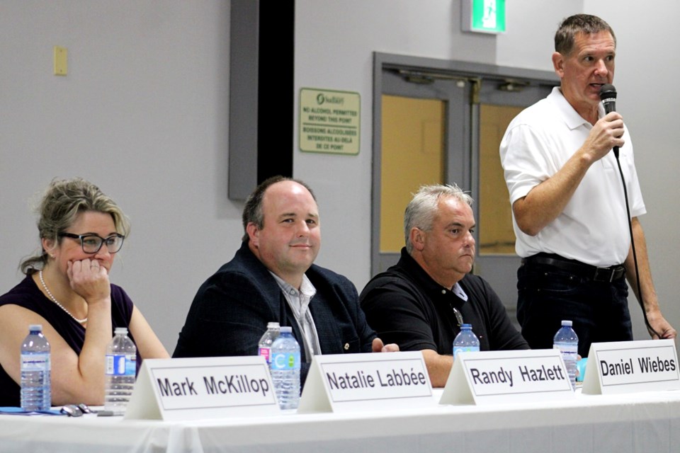 Ward 7 candidate Mark McKillop speaks during Monday night’s candidates debate at the Capreol Arena as his political opponents look on.