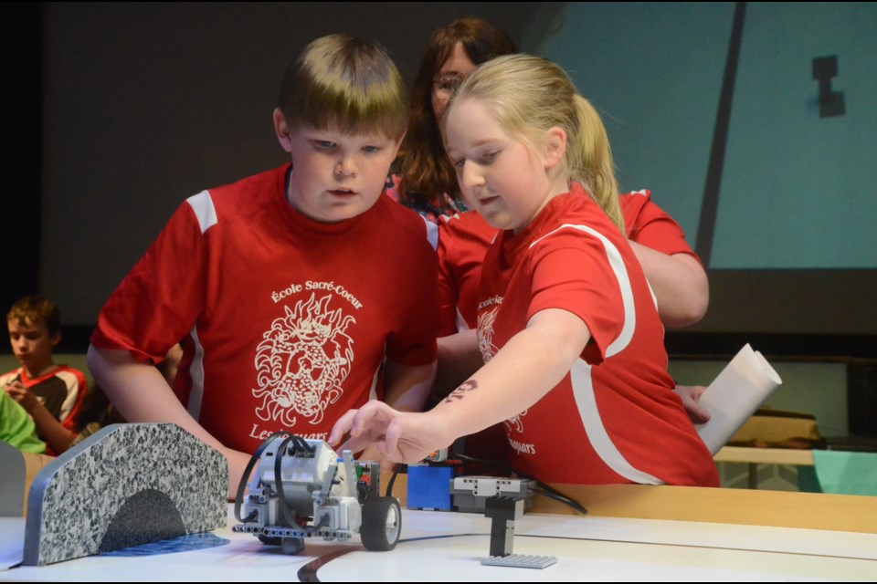 The team from École Sacré-Coeur in Chapleau discuss their next move during competition in the 15th edition of the Great Robotics Challenge (Le Grand Défi Robotique). (Arron Pickard/Sudbury.com)
