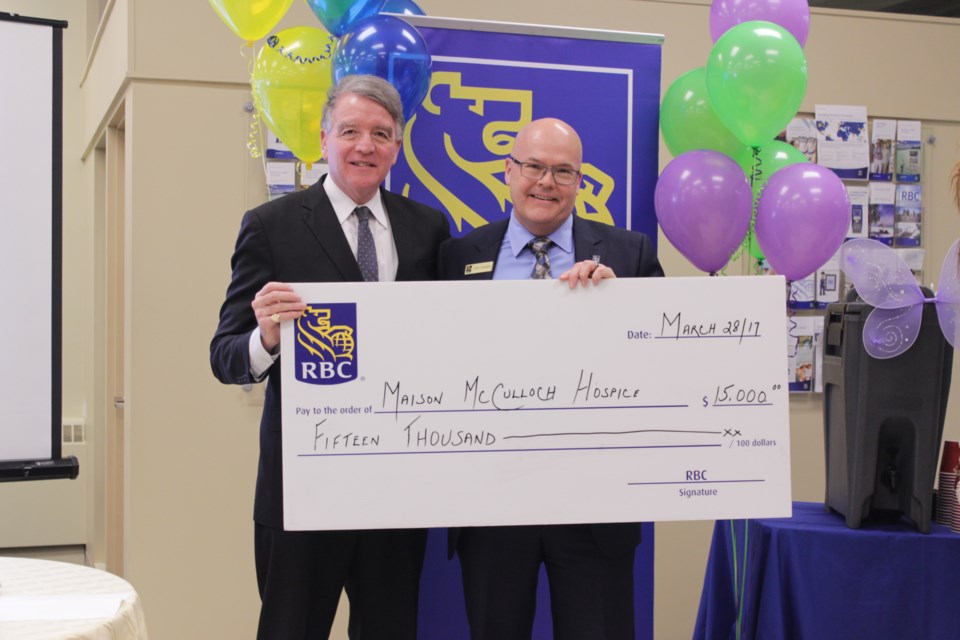 Scott Sonder (left), regional VP for RBC, presents a $15,000 donation March 28 to Gerry Lougheed, Jr., chair of the Maison McCulloch Hospice board at a kick-off event for the annual RBC Hike for Hospice. (Callam Rodya)